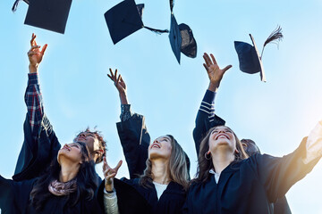 Students, group and throw graduation cap for success, celebration and happy with goals at college. People, friends and excited with mortarboard in air at event, education and cheers at university