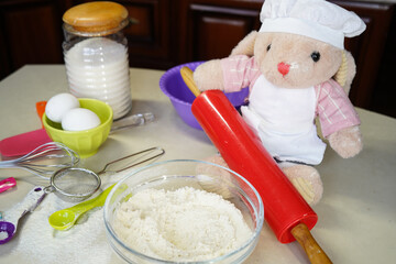 Toy hare cook, rabbit cooks dough at home