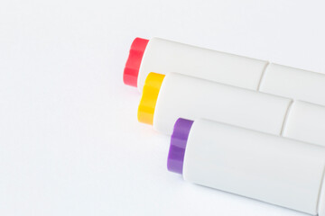 close up of three sketching markers lying on blank white page