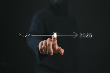 Fototapeta premium Businessman touch on virtual bar status to change from 2024 to 2025, countdown of merry Christmas and happy new year by technology concept, start new business and new life. New year's start-up.