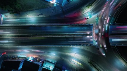 Time lapse of car traffic transportation above intersection road is important infrastructure in Bangkok Thailand, aerial view Hyperlapse cityscape of advanced innovation and financial technology.	

