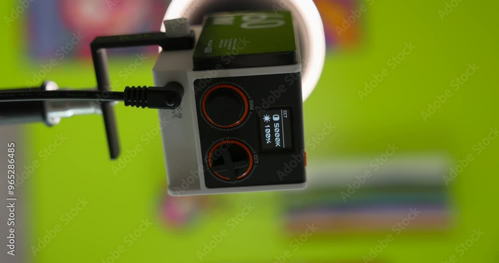 Poster close-up of a professional zhiyun tech led video light controller with display and dials, mounted on