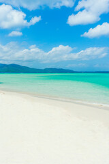 Beautiful sandy beach with white sand and turquoise ocean on Sunny day. Summer vacation and summer holiday concept.