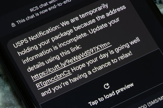 Portland, OR, USA - Sep 8, 2024: An unsolicited mobile text message indicating that a USPS delivery is awaiting the receiver's action with an unrecognized web link to click is seen on a smartphone.
