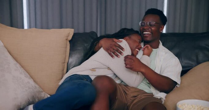 Laugh, happy and watching tv with black couple play fighting on sofa for streaming, subscription or date night. Remote, marriage and movie with man and woman at home for broadcast, tickle or film