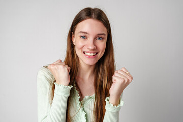 Young Woman Posing With Fists Up Celebrating Success