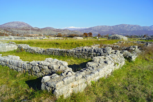 View from the Duklja Archaeological Park on the outskirts of Podgorica. The landmark of the Montenegrin capital: the ruins of the ancient Roman city of Doclea against the backdrop of a mountain range