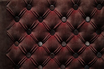 Elegant tufted leather texture in deep burgundy