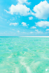 Beautiful sandy beach with white sand and rolling calm wave of turquoise ocean on Sunny day in Maldives. summer background and summer holiday concept.