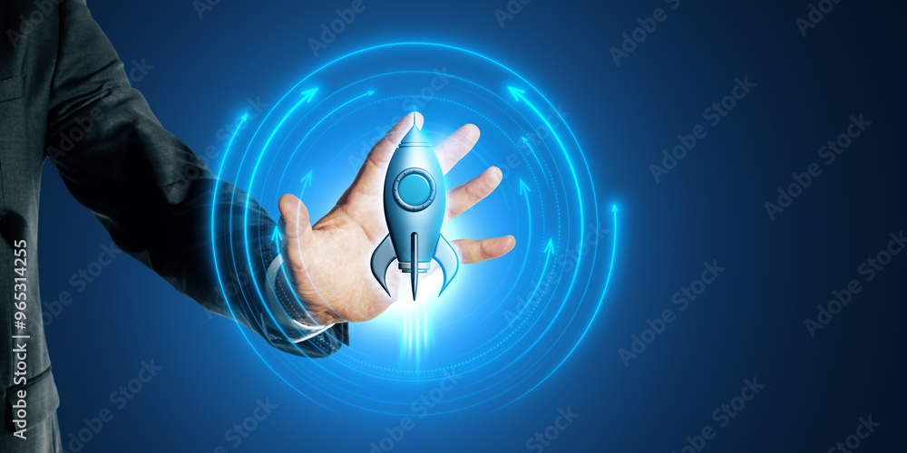 Poster close up of businessman hand using glowing rocket hologram on blue background. digital transformatio