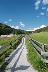 Local road at Santa Maddalena Landscape at Val di Funes, land of the pale mountains and valley in the Dolomites, UNESCO World Heritage- South Tyrol, Italy