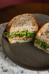 A roast beef sandwitch with salad on sourdough bread