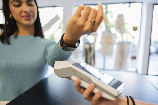 Customer doing online payment through smart watch at checkout