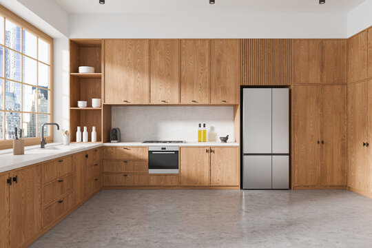 Stylish home kitchen interior with cooking cabinet and panoramic window