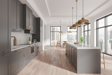 Home kitchen interior with eating table and cooking cabinet. Panoramic window