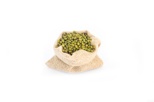 Green mung beans flso know as mung dal, vigna radiata, green beans or moong dal, Ceramic bowl of mung beans with wooden spoon on gray white background