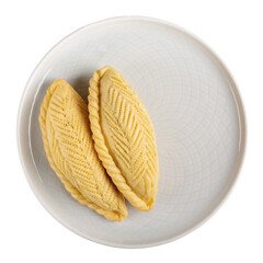 Shekerbura on plate isolated on white.  Sweet pastry in half-moon shape, filled with ground nuts...