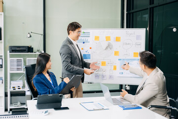 Office colleagues have a casual discussion. During a meeting in a conference room, a group of business teem