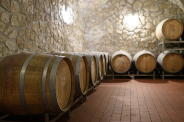 Wine cellar with oak barrels for aging wine. Traditional wine storage.