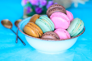 Cake macaron or macaroon bowl on turquoise