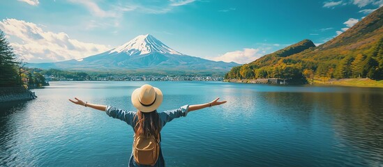 A serene landscape featuring a woman by a lake with a majestic mountain backdrop, celebrating nature's beauty and tranquility.