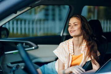 Young woman sitting in a car smiling, casual outfit, sunlight streaming through the window, relaxed ambiance, car interior in soft colors, summertime vibes and joyfulness