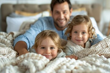 Fototapeta premium cozy family moment captured as two young children snuggle under the covers with their parents in bed. The scene conveys love, warmth, and togetherness in a comfortable home setting.
