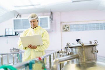 Quality control supervisor checking and collecting food and beverage producing data.