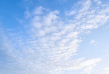 Fototapeta premium Clear blue sky with a single, fluffy white cloud drifting across it