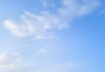 Clear blue sky with a single, fluffy white cloud drifting across it