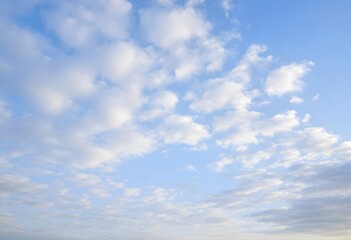 Obraz premium Clear blue sky with a single, fluffy white cloud drifting across it