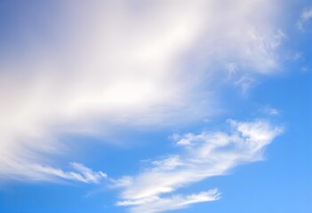Obraz premium Clear blue sky with a single, fluffy white cloud drifting across it