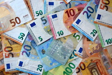 Many european euro money bills in chaotic arrangement. Pile of eur banknotes with different colors and condition