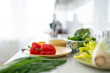 Set of fresh raw vegetables tomato, salad, pepper, squash on a white wood table in a modern kitchen room. Healthy Eating. Organic food.