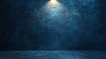 Dark blue textured wall with a single warm spotlight shining from above at a narrow angle, casting a soft glow with ample copy space for your design.