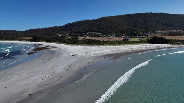 Drone flight over Diamond Island Bicheno and the azure waters in Tasmania, Australia.