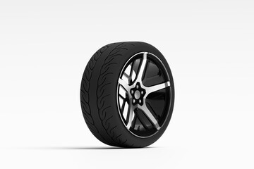 Obraz premium Black tire with alloy wheel standing on white background