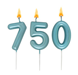 Burning blue birthday candles isolated on white background, number 750