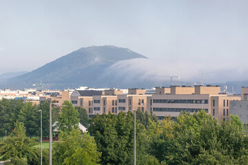Obraz premium Sarriguren, Egüés Valley. Navarre. Mount Ezkaba between mists in the background
