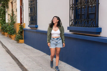 Smiling woman walking down a street in Santa Marta, Colombia