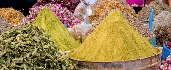 Spices, herbs and henna powder at traditional oriental market. Spices in buckets at Souk in Agadir, Morocco