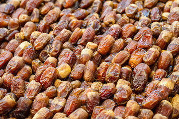 Dried dates at souk in Morocco. Pile of dates fruit at market stall filling all frame. Organic dried fruits as healthy alternative for sweets