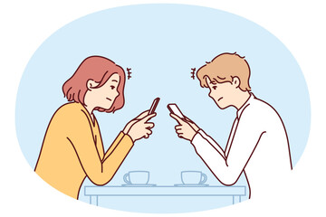 Couple with phones sits in cafe, addiction to social networks and internet chatting, not paying attention to interlocutor. Concept of social problems associated with digital addiction to gadgets