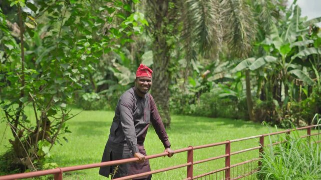 A smiling male model in an African garden.