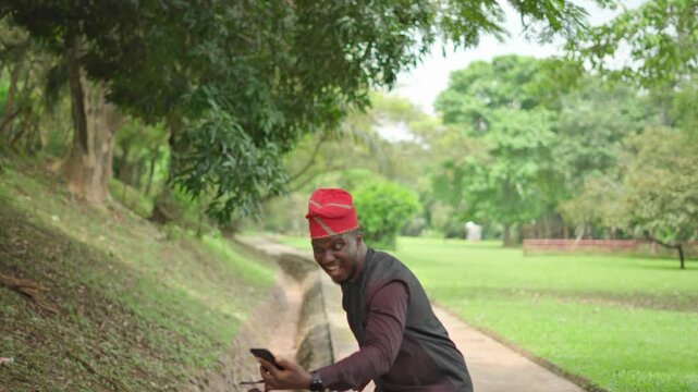 Panning shot up of a successful business news dancing of an African-American male in a Nigeria Yoruba attire.
 