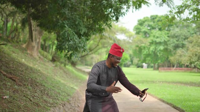 Good news on the phone as Yoruba man dances to it.
