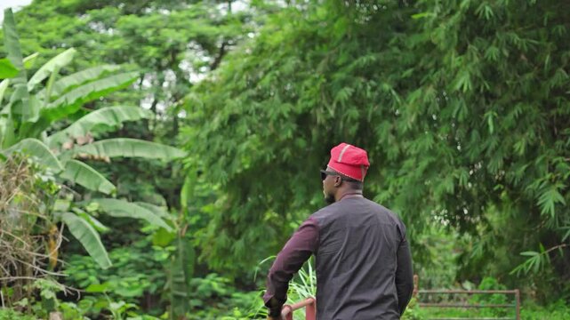 Back-shot of a Yoruba man staring into the future.
 