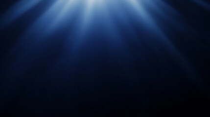 Rich navy blue background with a soft spotlight casting light from above at a narrow angle, creating a smooth glow and space for minimalist text.