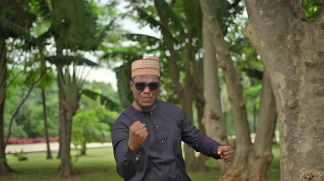 An African man gives powerful double thumbs up 
to the camera and ends with an emphatic fist pump.