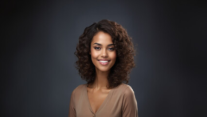 A beautiful brunette model with a healthy complexion and a warm smile is pictured against a clean studio background. Her professional appearance and natural beauty